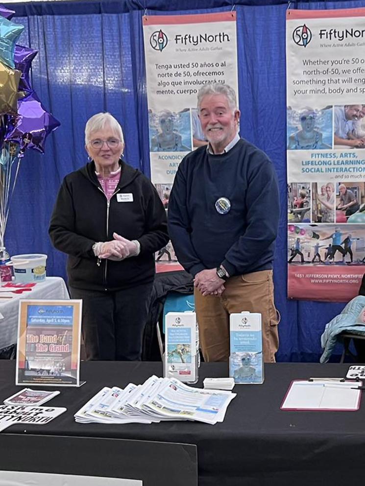 A woman and a man at a FiftyNorth information booth