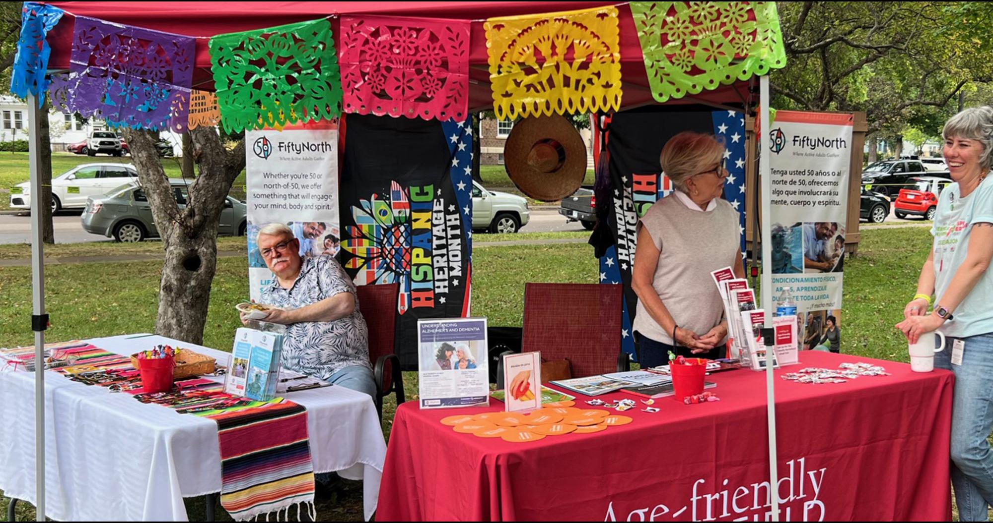 Volunteer at booth during Hispanic Heritage celebration