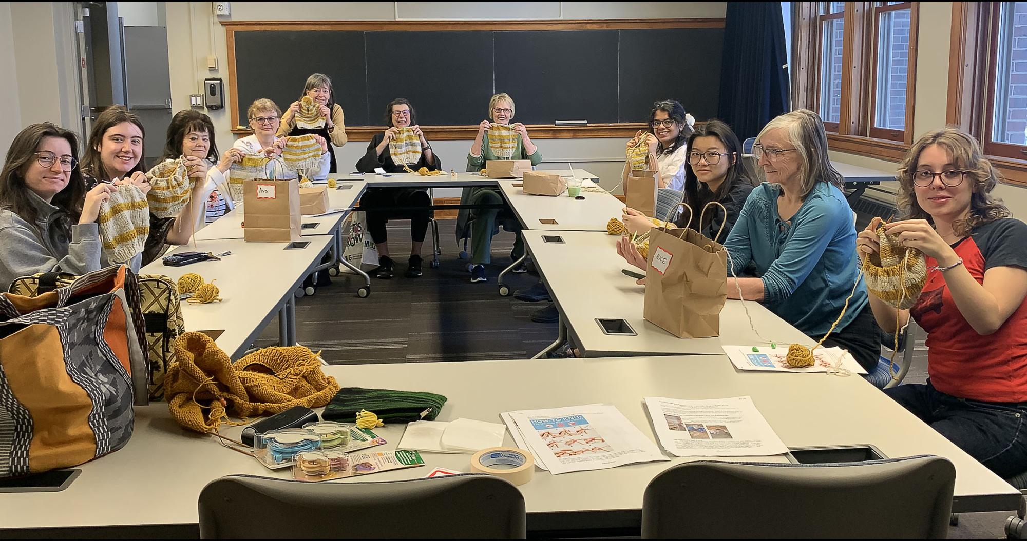 Members teaching Carleton students knitting