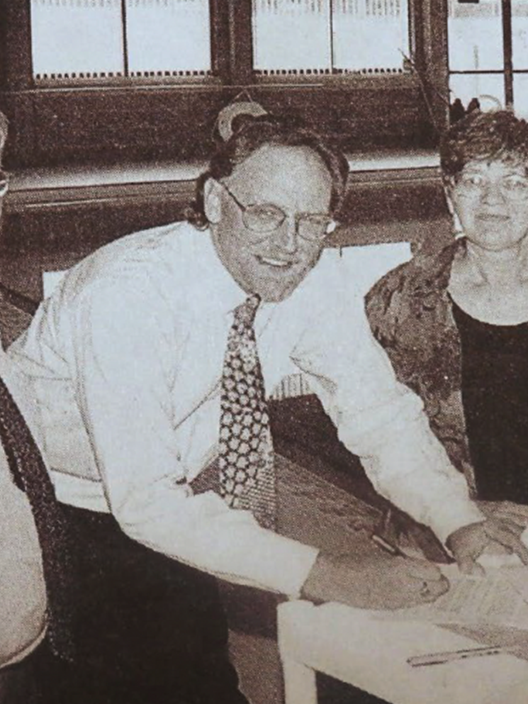 Ailene Fink prepares to sign lease with city officials